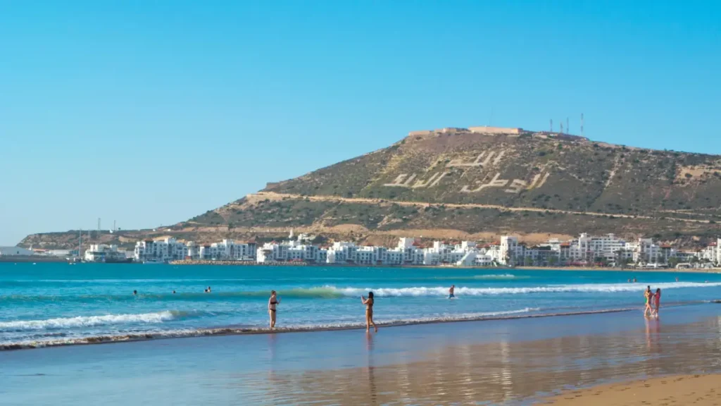 Best time to visit Agadir — wide beach with Atlas Mountains in the distance, Morocco.