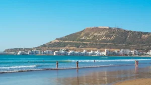 Best time to visit Agadir — wide beach with Atlas Mountains in the distance, Morocco.